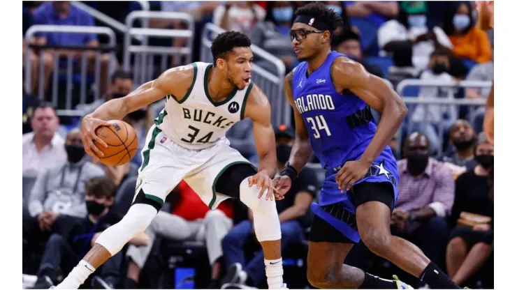 Giannis Antetokounmpo #34 of the Milwaukee Bucks drives to the basket against Wendell Carter Jr. #34 of the Orlando Magic
