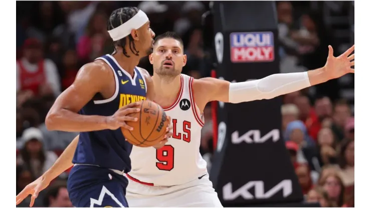 Nikola Vucevic #9 of the Chicago Bulls defends Zeke Nnaji #22 of the Denver Nuggets
