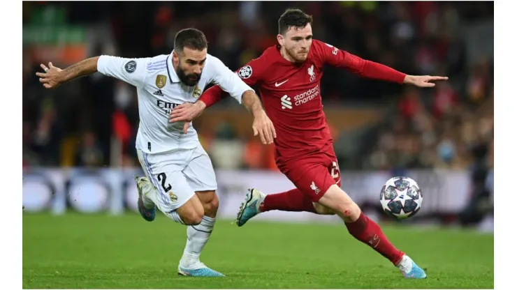 Andrew Robertson of Liverpool runs with the ball whilst under pressure from Daniel Carvajal of Real Madrid
