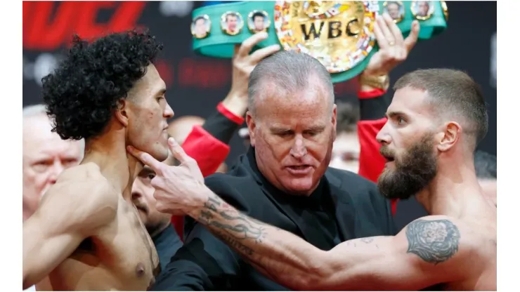 Super middleweight boxers David Benavidez (L) and Caleb Plant get into a scuffle as they face off
