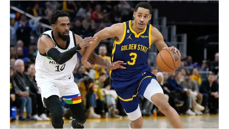 Jordan Poole #3 of the Golden State Warriors drives towards the basket past Mike Conley #10 of the Minnesota Timberwolves
