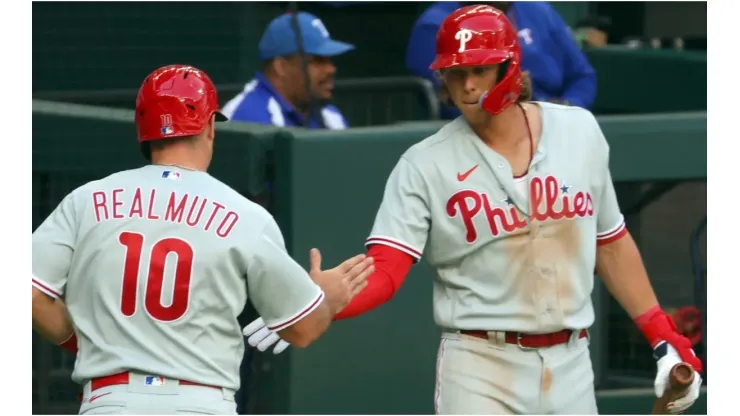 J.T. Realmuto #10 of the Philadelphia Phillies is greeted by teammate Alec Bohm
