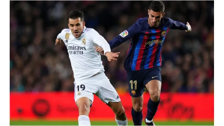 Dani Ceballos of Real Madrid battles for possession with Ferran Torres of FC Barcelona
