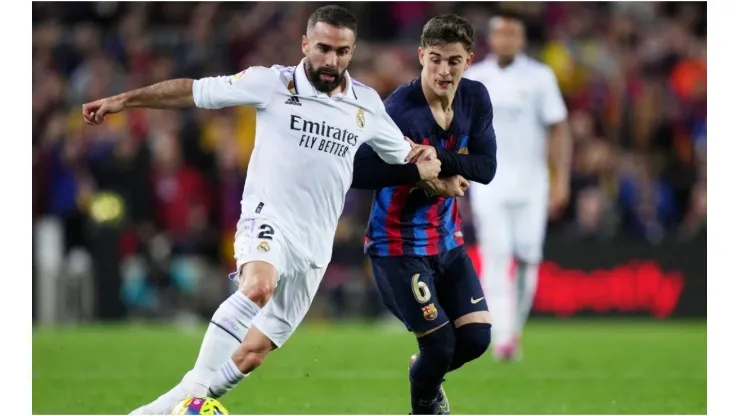 Daniel Carvajal of Real Madrid battles for possession with Gavi of FC Barcelona
