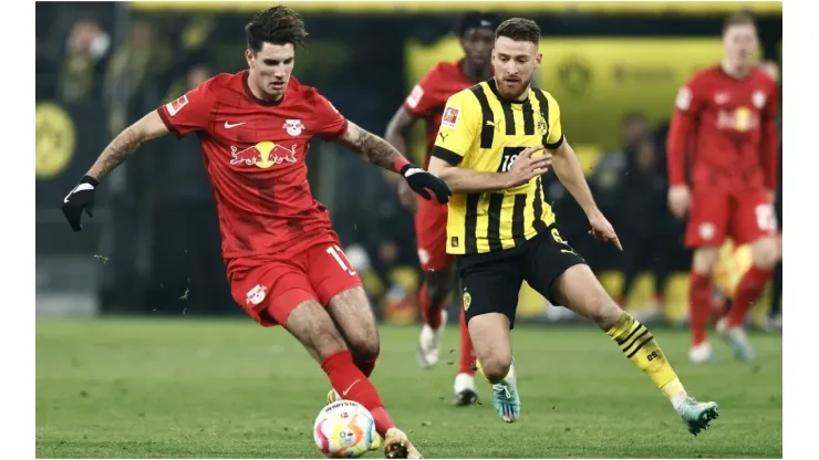 Salih Oezcan of Dortmund (R) challenges Dominik Szoboszlai of Leipzig
