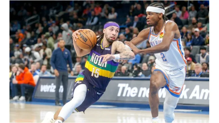 Jose Alvarado #15 of the New Orleans Pelicans drives past Shai Gilgeous-Alexander #2 of the Oklahoma City Thunder
