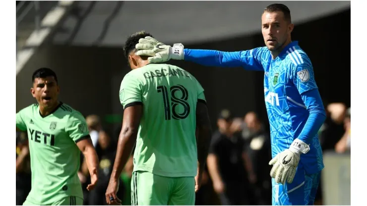 Goalkeeper Brad Stuver #1 congratulates Julio Cascante #18 of Austin FC
