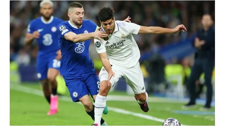 Marco Asensio of Real Madrid is challenged by Mateo Kovacic of Chelsea
