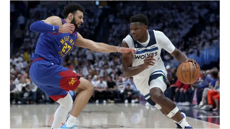 Anthony Edwards #1 of the Minnesota Timberwolves drives against Jamal Murray #27 of the Denver Nuggets
