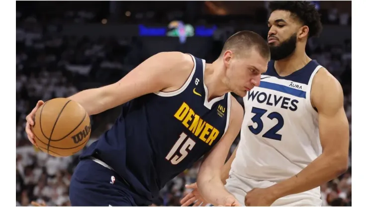 Nikola Jokic #15 of the Denver Nuggets drives the ball against Karl-Anthony Towns #32 of the Minnesota Timberwolves
