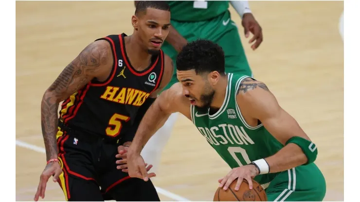 Jayson Tatum #0 of the Boston Celtics drives against Dejounte Murray #5 of the Atlanta Hawks
