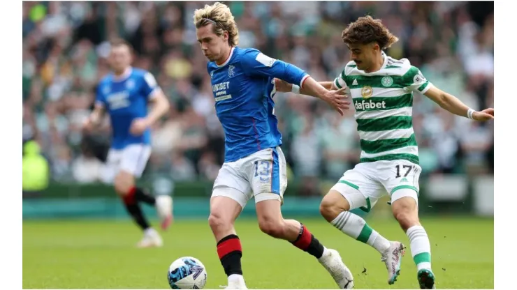 Todd Cantwell of Rangers FC is put under pressure by Jota of Celtic
