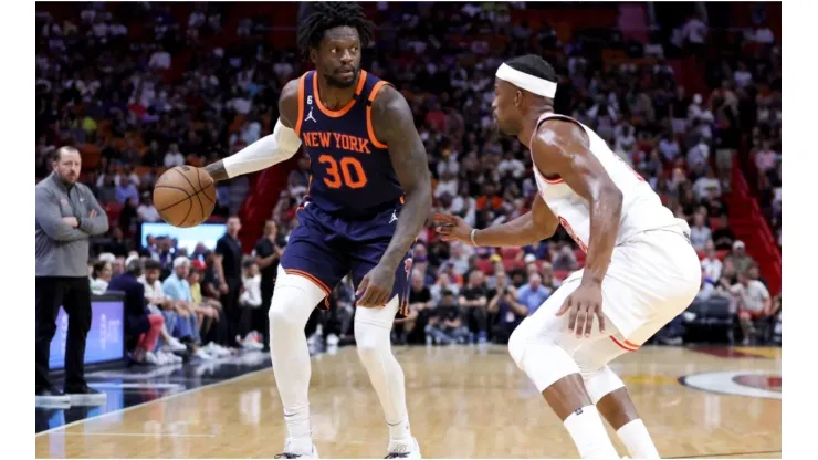 Julius Randle #30 of the New York Knicks dribbles the ball against Jimmy Butler #22 of the Miami Heat
