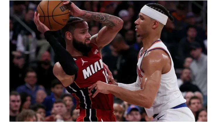 Caleb Martin #16 of the Miami Heat tries to pass as Josh Hart #3 of the New York Knicks
