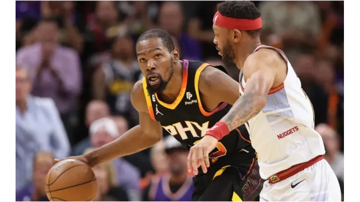 Kevin Durant #35 of the Phoenix Suns handles the ball against Bruce Brown #11 of the Denver Nuggets
