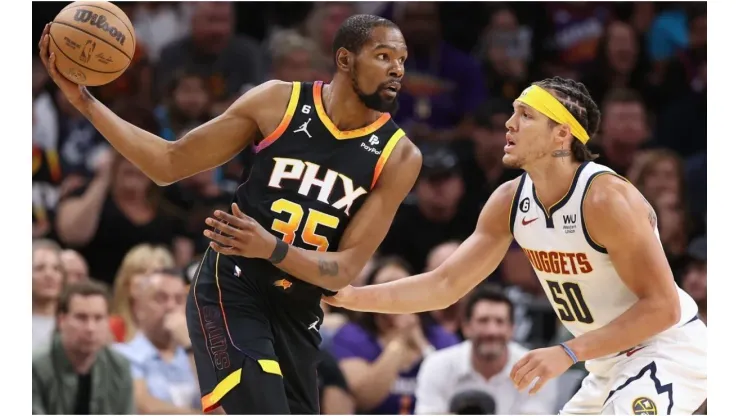 Kevin Durant #35 of the Phoenix Suns handles the ball against Aaron Gordon #50 of the Denver Nuggets
