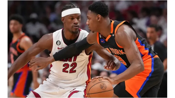 RJ Barrett #9 of the New York Knicks dribbles upcourt while being defended by Jimmy Butler #22 of the Miami Heat
