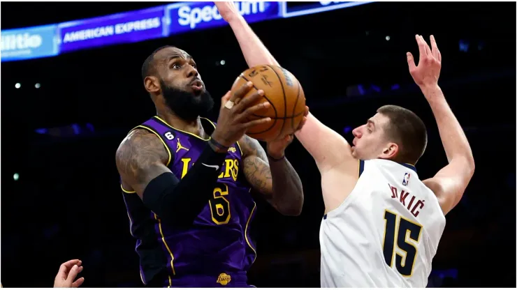 LeBron James #6 of the Los Angeles Lakers takes a shot against Nikola Jokic #15 of the Denver Nuggets
