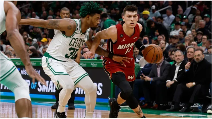 Tyler Herro #14 of the Miami Heat drives on Marcus Smart #36 of the Boston Celtics
