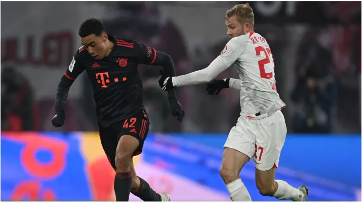 Jamal Musiala of Bayern Muenchen is challenged by Konrad Laimer of Leipzig
