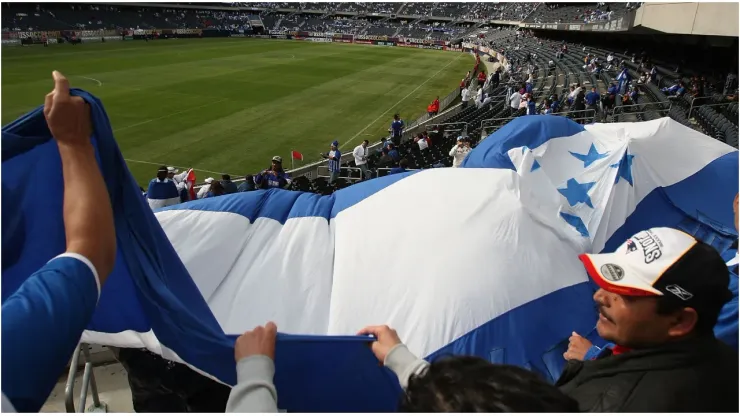 Fans of Honduras wave a flag
