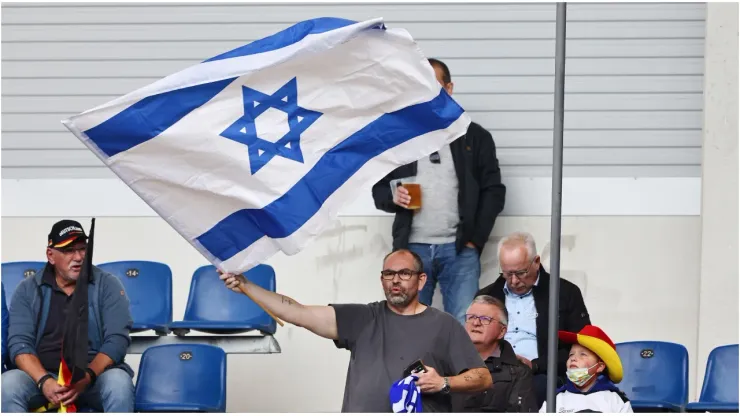 A fan of Israel waves a flag
