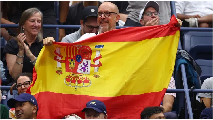 A fan holds up the flag of Spain
