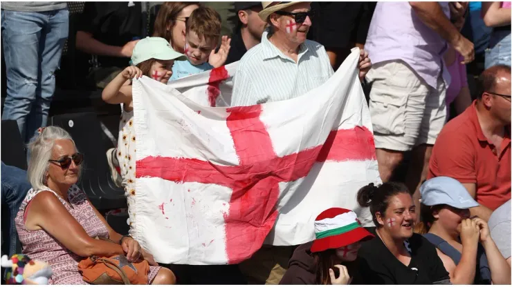 Fans hold a large English flag
