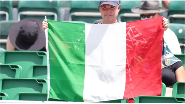 A fan holds an Italian flag
