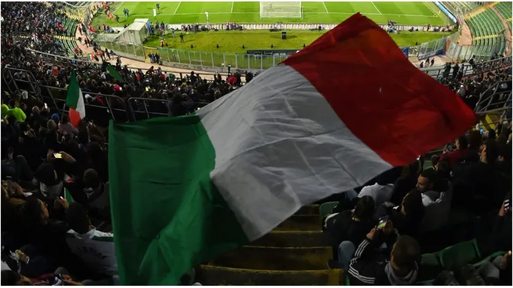 A general view inside the stadium as a fan waves the flag of Italy
