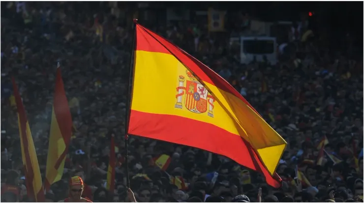 A Spain supporter flies the national flag
