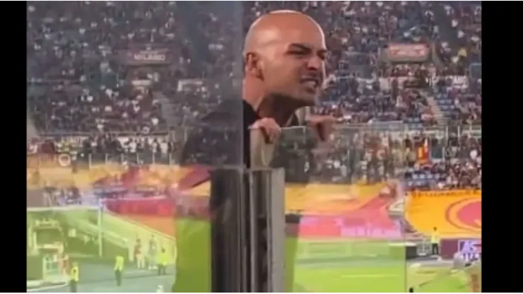 AC Milan fan yelling at Roma supporters.
