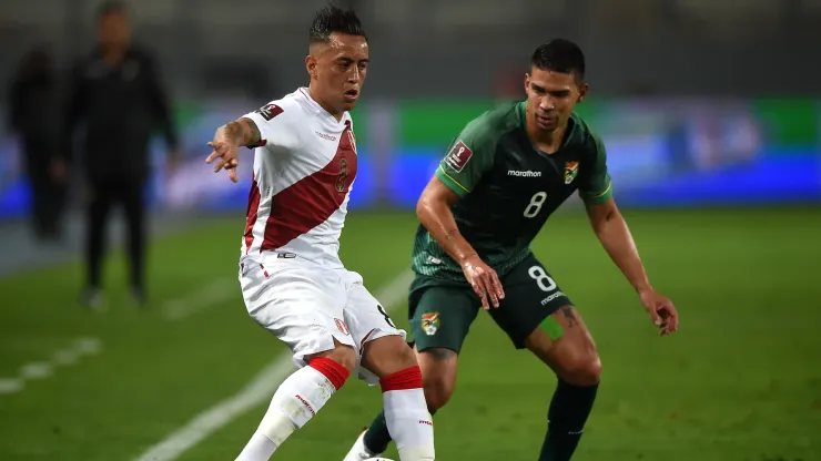 Christian Cueva of Peru competes for the ball with Diego Bejarano of Bolivia in 2021.
