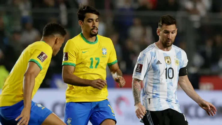 Lionel Messi competes for the ball with Lucas Paquetá (C) and Danilo da Silva (L) during a match in 2021.
