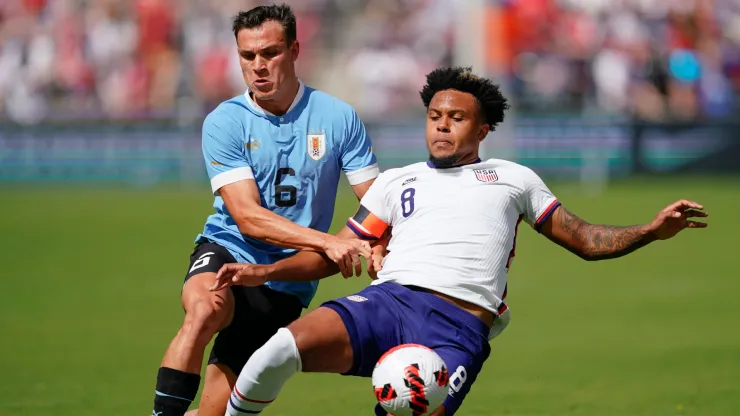 Manuel Ugarte #6 of Uruguay has the ball knocked away by Weston McKennie #8 of USA during the first half of the friendly matchat Children's Mercy Park on June 05, 2022 in Kansas City, Kansas. 
