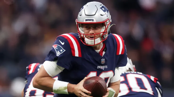 Mac Jones of the New England Patriots looks to hand the ball off.
