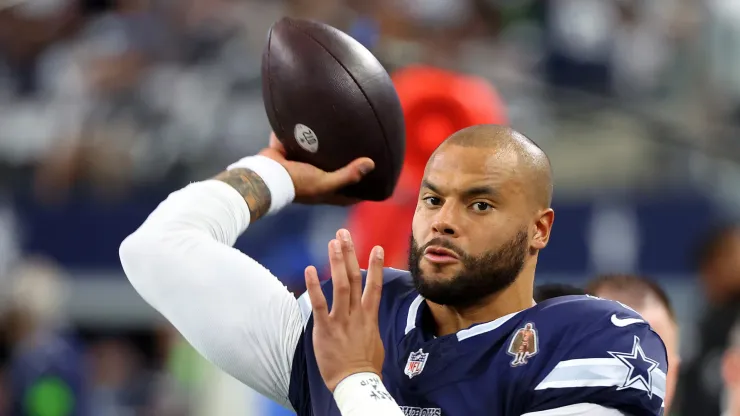 Dak Prescott of the Dallas Cowboys warming up on the sidelines.
