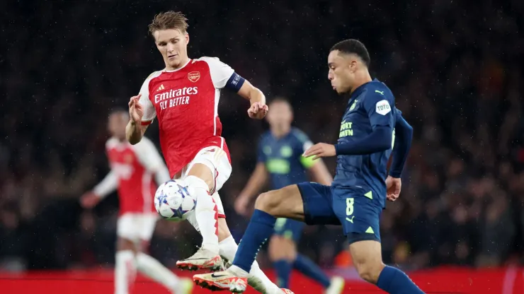 Martin Oedegaard of Arsenal and Sergino Dest of PSV Eindhoven battle for possession.
