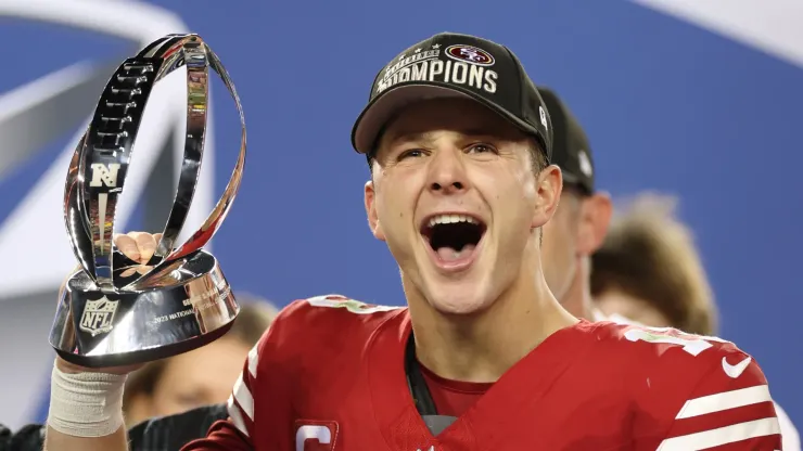 Brock Purdy #13 of the San Francisco 49ers reacts as he holds the George Halas Trophy after defeating the Detroit Lions 34-31 in the NFC Championship Game at Levi's Stadium on January 28, 2024 in Santa Clara, California.
