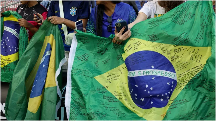 Fans hold Brazil flags
