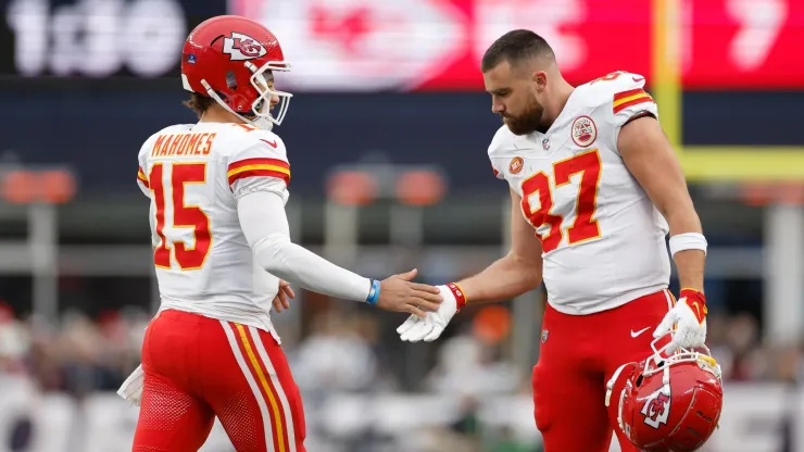 Patrick Mahomes #15 and Travis Kelce #87 of the Kansas City Chiefs high five during the first half against the New England Patriots at Gillette Stadium on December 17, 2023 in Foxborough, Massachusetts.
