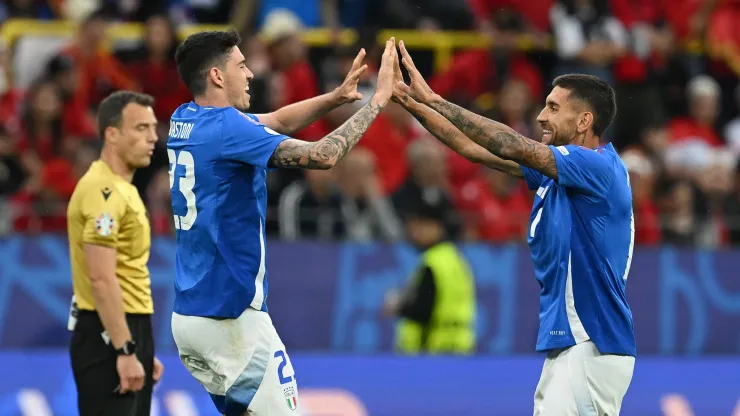 Alessandro Bastoni of Italy celebrates scoring his team's first goal with a header with teammate Lorenzo Pellegrini during the UEFA EURO 2024 group stage match between Italy and Albania.
