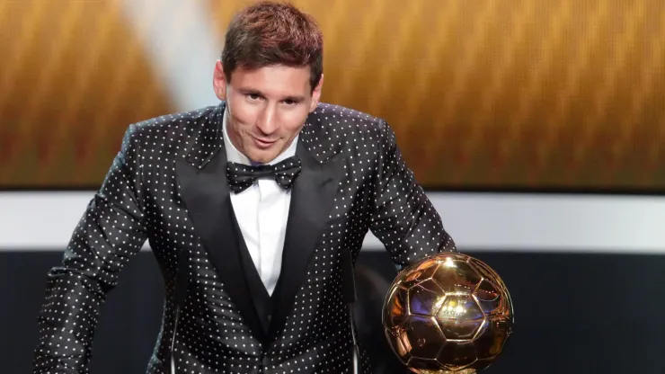 Lionel Messi of Argentina receives the FIFA Ballon d'Or 2012 trophy.
