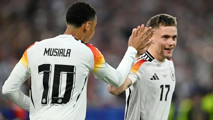 Florian Wirtz of Germany celebrates scoring his team's first goal with teammate Jamal Musiala during the UEFA EURO 2024 group stage match between Germany and Scotland
