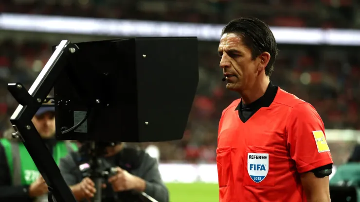 Referee Deniz Aytekin checks the VAR during the International friendly between England and Italy at Wembley Stadium
