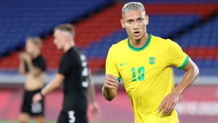 Richarlison #10 of Brazil celebrates after scoring their side's second goal during the Men's First Round Group D match between Brazil and Germany
