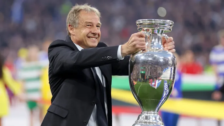 Jurgen Klinsmann, German former professional player and manager, holds the UEFA Euro 2024 Henri Delaunay Trophy prior to kick-off ahead of the UEFA EURO 2024 group stage match.
