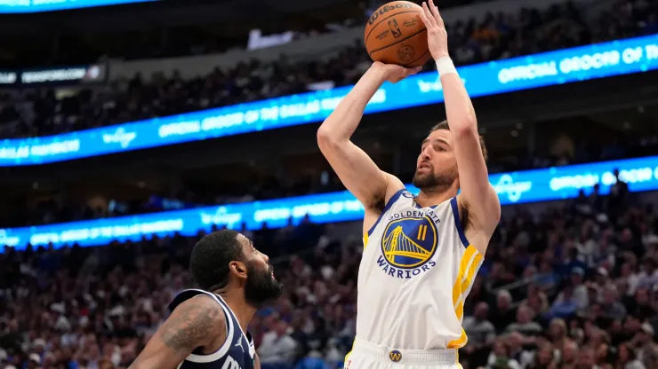 Klay Thompson #11 of the Golden State Warriors shoots the ball against Kyrie Irving #11 of the Dallas Mavericks during the second half at American Airlines Center on April 05, 2024 in Dallas, Texas. 
