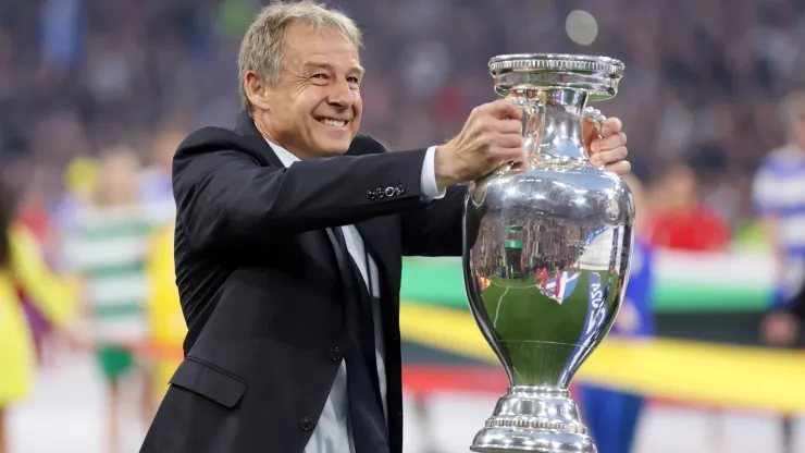 Jurgen Klinsmann, German former professional player and manager, holds the UEFA Euro 2024 Henri Delaunay Trophy prior to kick-off ahead of the UEFA EURO 2024
