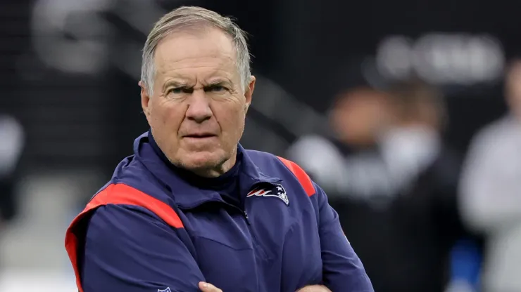 Head coach Bill Belichick of the New England Patriots watches his players warm up before a game against the Las Vegas Raiders at Allegiant Stadium on December 18, 2022 in Las Vegas, Nevada. The Raiders defeated the Patriots 30-24.
